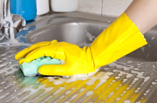 Kitchen cupboards and surfaces being cleaned in a Pimlico property