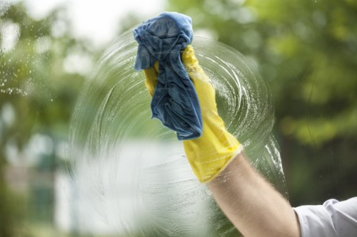 Cleaner Pimlico operative wearing PPE while cleaning a surface